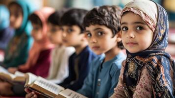 Focused young children studying religious texts in a classroom setting. photo