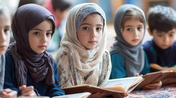 Young children attentively studying religious texts. photo