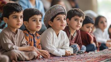 Attentive young children seated on a patterned floor. photo