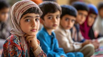 Close-up view of thoughtful children seated in a group. photo