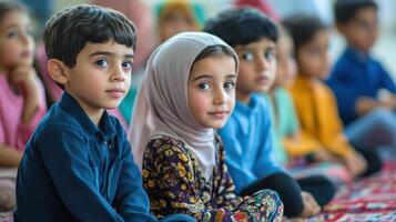 Attentive young children seated in a group. photo
