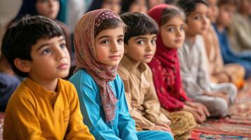 Attentive young children seated in a row. photo