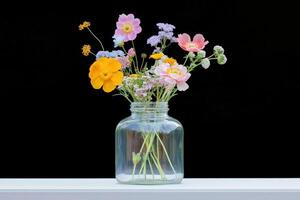Mixed Flower Arrangement in Clear Glass Jar photo