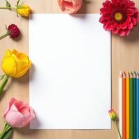 Blank Paper Surrounded by Flowers and Colored Pencils photo