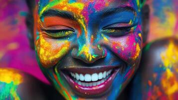 Smiling Woman Covered Colors, Celebrate Joy with Vibrant Facial Expression photo