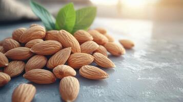 Pile of Almonds with Green Leaves on Stone Surface. Fresh Nuts Ready to Eat photo