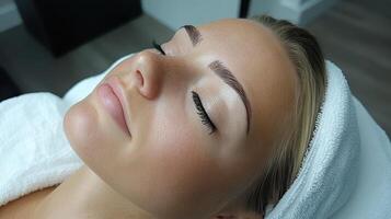 Beautiful Woman Relaxing with Fluffy Eyebrows and Eyelashes Treatment in Salon photo