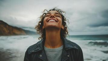 Happy Woman Enjoying Nature's Beauty with Wide Smile on Beach with Ocean Breeze photo