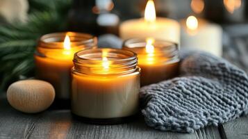 Warm Glow of Jar Candles. Cozy Ambiance with Knit Blanket and Evergreen Twigs photo