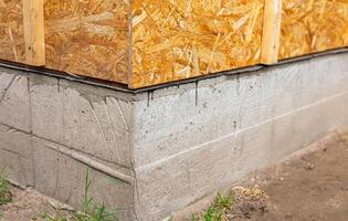 Waterproofing of the house foundation Close-up of the house foundation with waterproofing. photo