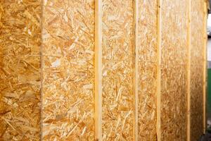 OSB panels. The walls of the frame house are sheathed with OSB boards for further finishing. Construction of frame houses and their cladding. photo