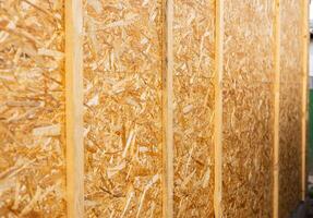 Sheathing of the house with OSB panels The walls of the frame house are sheathed with OSB boards for further finishing. Construction of frame houses and their cladding. photo