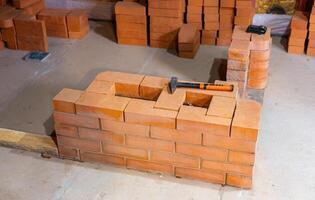 Construction of a stove to heat a wooden house. Assembly of the stove structure for heating a room. photo