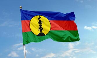 Flag of New Caledonia with tricolor bands and traditional emblem photo