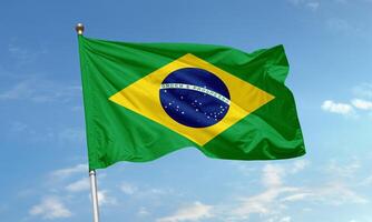 Brazil national flag with green field, yellow diamond and starry blue globe waving proudly in the clear sky photo