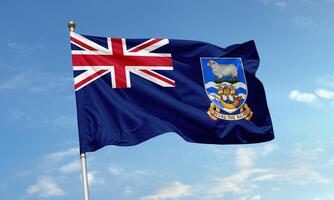 Falkland Islands flag with Union Jack and coat of arms waving in sky photo