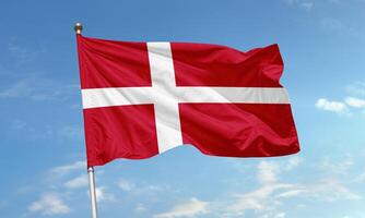 Denmark national flag with Nordic cross waving in the sky photo