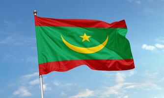 Waving flag of Mauritania with crescent and star on green, red and yellow background photo