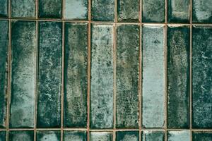 A pattern of modern vertical rectangular malachite tiles. Realistic texture. The walls are lined with green ceramic tiles with space for copying photo