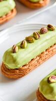 A close-up of a pistachio-flavored eclair, showcasing its rich frosting, green nuts, and golden pastry. A tempting dessert perfect for connoisseurs of fine bakery treats. photo