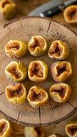 Halved ripe figs displayed on a wooden surface with visible seeds, evoking freshness and rustic charm. Ideal for culinary presentations, natural themes, or health-inspired projects. photo