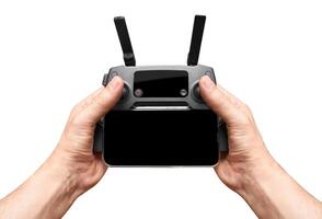 Drone remote control in a hand, isolated on a white photo