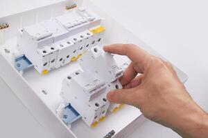 Automatic circuit breakers with hand, isolated on a white background photo