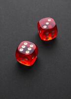 Red and white dices on a black photo