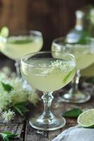 Sparkling elderflower cocktails with lime and fresh green garnish. photo