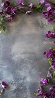 Elegant gray background with purple orchids and green leaves. photo