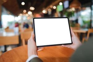 Person Holding Tablet with Blank Screen in a Cafe Mockup for App or Website Design photo