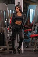 Fitness enthusiast showcases strength and style in a gym setting with workout attire and confident pose photo