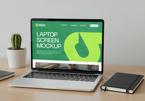 A laptop displaying a website mockup sits on a desk beside a cactus and notebook psd