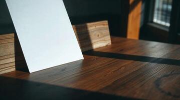 A photo of a wooden desk and paper. High contrast, deep shadows, and visible wood grain create a moody, urban style.