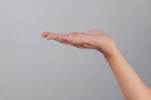 Outstretched human hand facing upward in horizontal position suggesting receiving, offering, or supporting action with fingers extended naturally on clean background photo