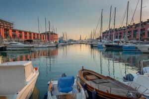 Genoa, Italy - 06 06 2021. The old port of Genoa at sunset with Lanterna lighthouse. photo