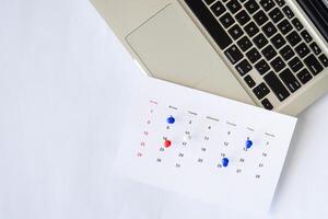 laptop with calendar and flat lay background copy space photo