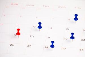 date with push pin on a calendar photo