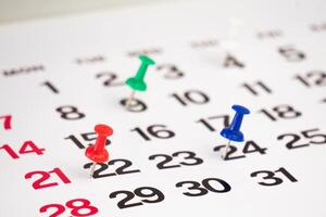 date with push pin on calendar photo