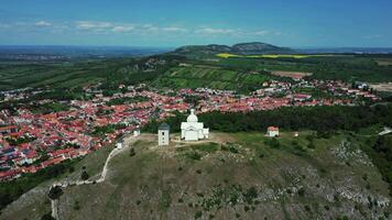 Aerial orbiting view of Chapel of St. Sebastian on holly hill in Mikulov in May 2025 in Czechia video