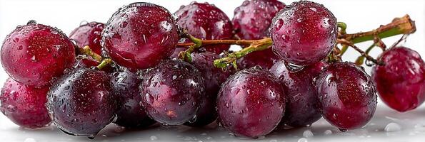 Fresh grapes with water droplets on a white surface. photo