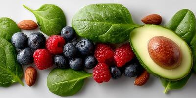 Fresh fruits and greens arranged artistically on a light background. Wellness healthy diet. photo