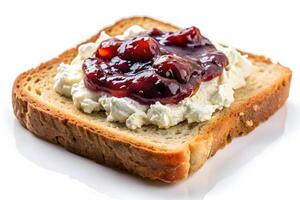 Close-up of a slice of toast topped with cream cheese and fruit jam. photo