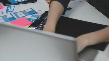 A person working on a laptop with sticky notes on it video
