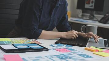 A woman is working on a laptop with a design on it video