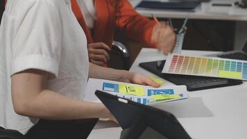 A woman is holding a piece of paper with a color chart video