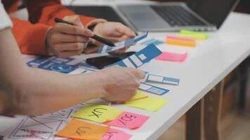 A person is working on a laptop and using sticky notes video