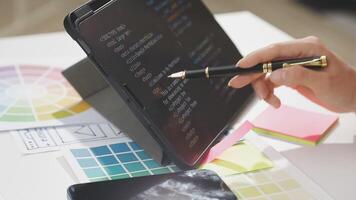 A person using a tablet to design a website video