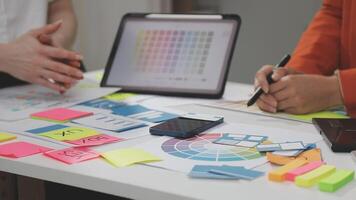 A group of people working on a project with colorful paper video