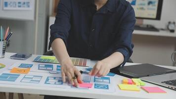 A woman is working on a design project at a desk video